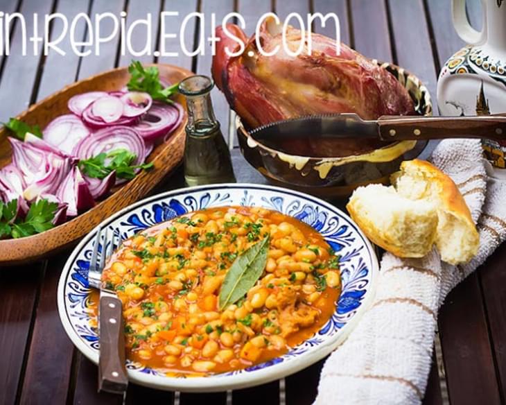 Romanian baked beans with smoked pork knuckle. Traditional baked beans with smoked meat.