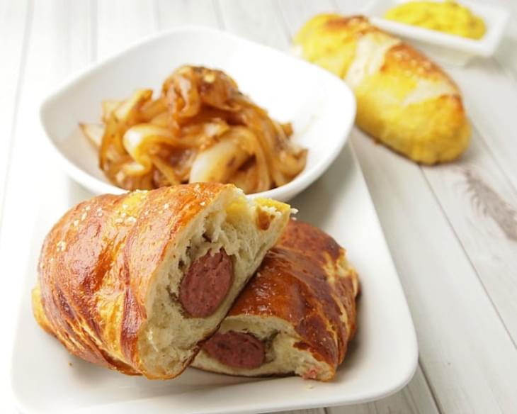 Pretzel Wrapped Brats with Cider Braised Onions