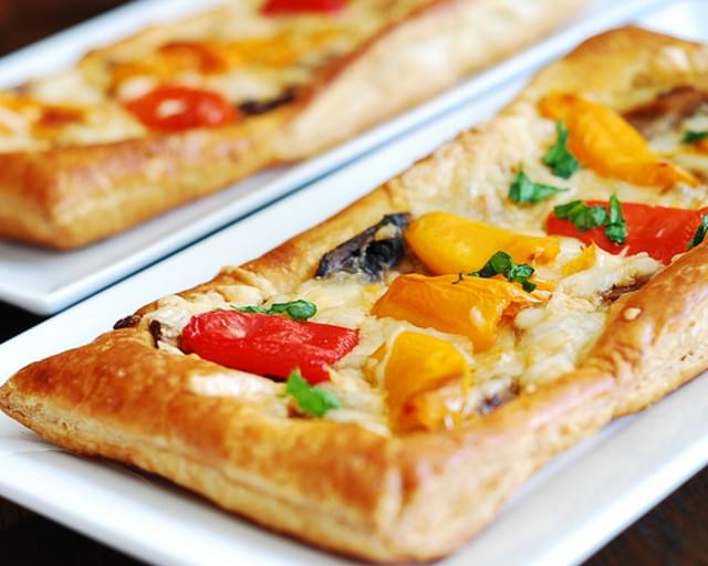 Puff pastry pizza with bell peppers, mushrooms, Mozzarella and Parmesan cheese