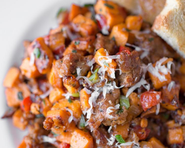 Autumn Sweet Potato Hash with Spicy Italian Sausage, Red Bell Peppers and Caramelized Onions, topped with a sprinkle of Fresh Herbs and Asiago Cheese