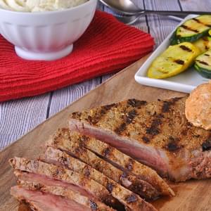Grilled peppered New York strip steak with spiced blue cheese