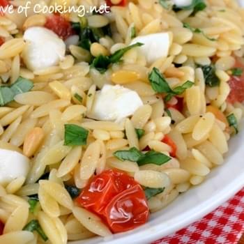 Orzo with Sautéed Garlicky Spinach and Tomatoes topped with Mozzarella and Toasted Pine Nuts